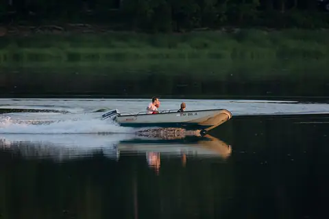 Classic Boston Whaler skiff running at sunset
