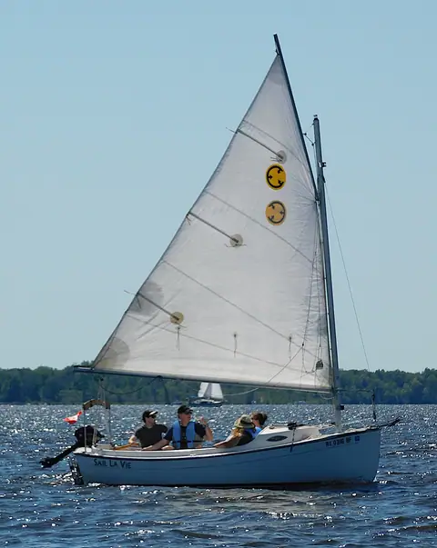 Com-Pac Sunday Cat under sail with three aboard