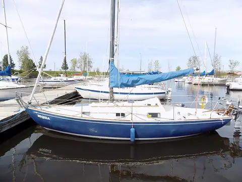 Blue-hulled Contessa 26 at a marina dock