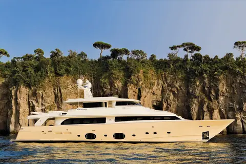 Custom Line Navetta 33 anchored below cliffs