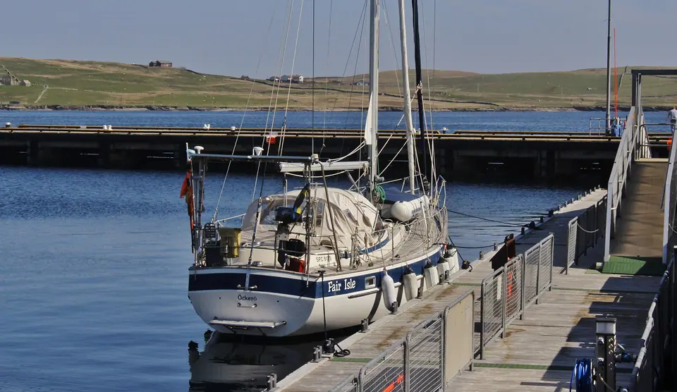 Stern of a Hallberg-Rassy 382 at a Lerwick pontoon