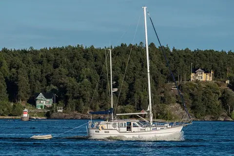 White Nauticat ketch motorsailer under way near Vaxholm, Sweden