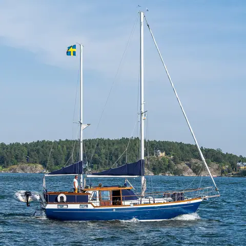 Blue-hulled Nauticat ketch with a teak wheelhouse near Vaxholm, Sweden
