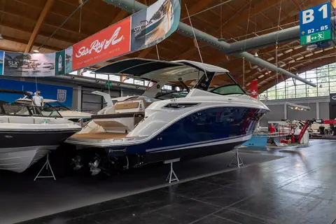 Sea Ray Sundancer 320 with a blue hull at a boat show