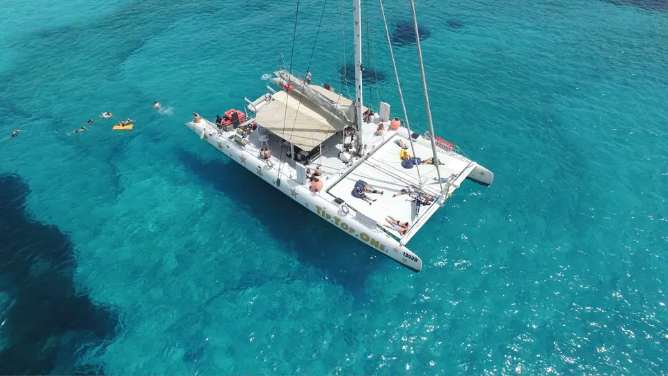 Aerial view of a charter sailing catamaran in clear water off Malta