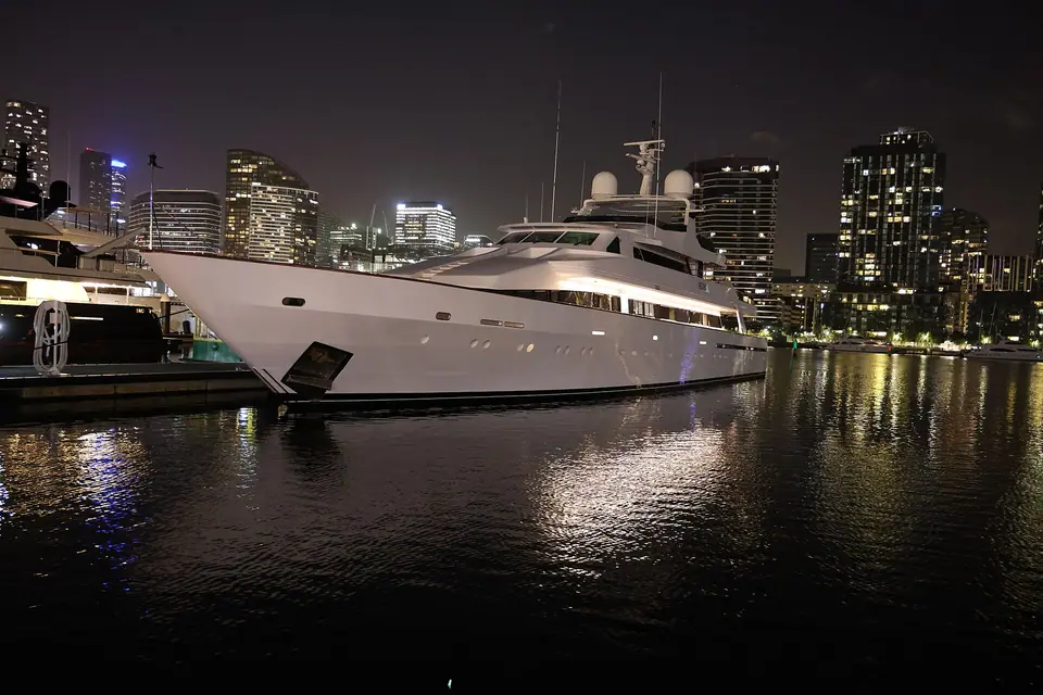 Large motor yacht moored at night in Melbourne Docklands