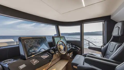 Absolute Navetta 64 lower helm station with twin displays and a leather helm seat
