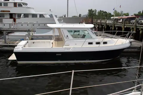 Albin 28 Tournament Express in profile at a dock showing the hardtop and open cockpit