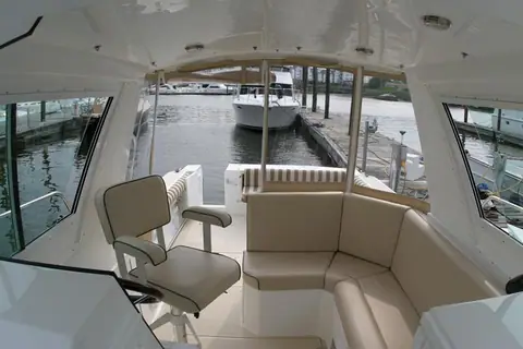 Albin 28 Tournament Express wheelhouse with helm chair and L shaped settee looking aft