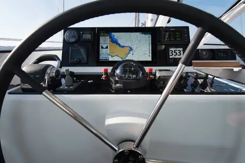 Amel 50 helm station under the hard dodger with wheel, chartplotter and engine controls