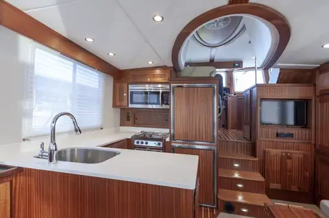 American Tug 435 galley with white counters and steps up to the pilothouse