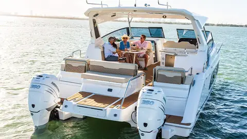 Aquila 36 Sport stern with twin Mercury outboards, aft seating and the shaded cockpit