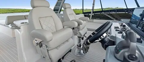Aquila 50 Yacht flybridge helm with twin white helm seats and wheel