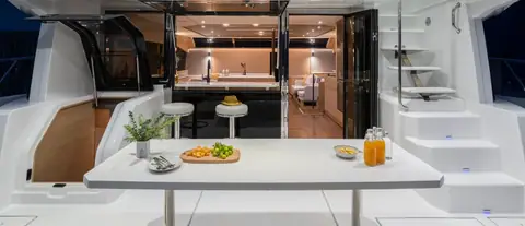 Aquila 54 Yacht aft cockpit table looking forward into the galley and salon