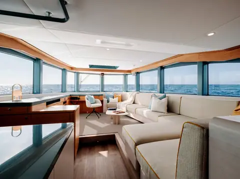 Arksen 85 main deck saloon with a large sofa and wraparound windows