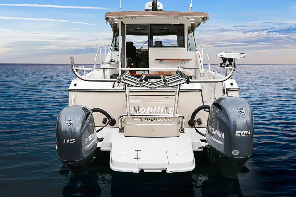 Aspen C108 transom showing its unequal twin Yamaha outboards and the cockpit door