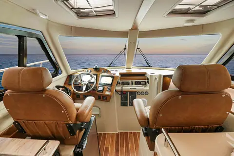 Aspen C108 pilothouse helm with two leather helm chairs and wraparound windows