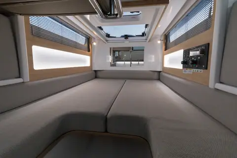 Axopar 28 Cabin forward berth under the deck hatch with grey upholstery