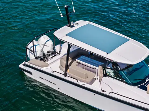 Axopar 29 Sun Top from above showing the glass roof canopy, cockpit seating and single outboard