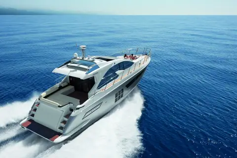 Azimut 55S seen from above and astern carving a turn on deep blue water
