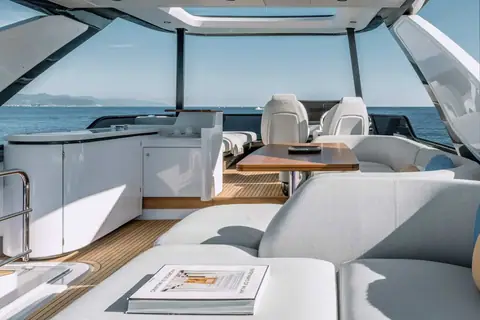 Azimut 68 flybridge with helm seats, wet bar, dining table and sun pads
