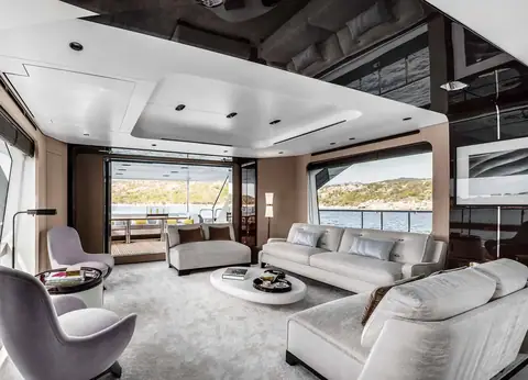 Azimut Grande 27 Metri main salon with grey sofas, armchairs and full height windows