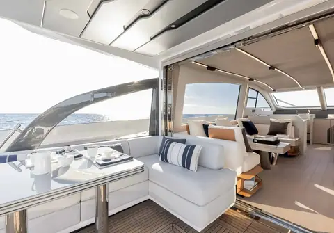 Azimut S7 aft cockpit dinette opening into the main salon through glass doors