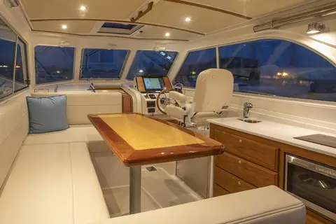 Back Cove 34O saloon with dinette, galley and helm seat under the hardtop