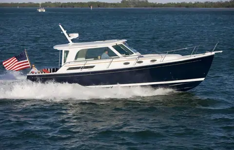 Back Cove 37 downeast cruiser with a navy hull running at speed in profile