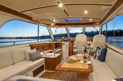 Back Cove 37 saloon with L shaped settee, galley and twin helm seats