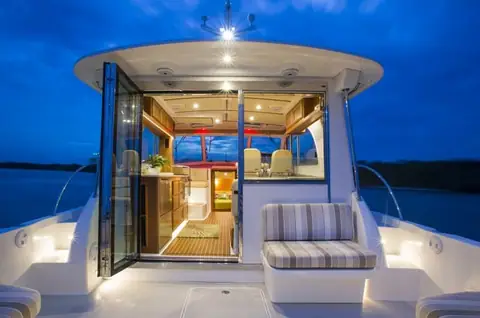 Back Cove 41 cockpit with stern seating and open doors into the saloon at night