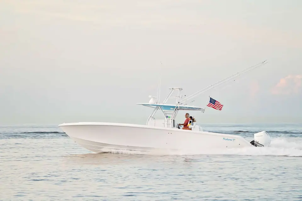 Bahama 37 in profile cruising on calm water under a T top