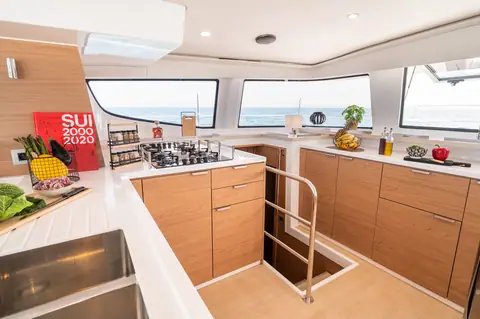 Bali 4.6 galley with oak cabinetry and the companionway down to the hull cabins