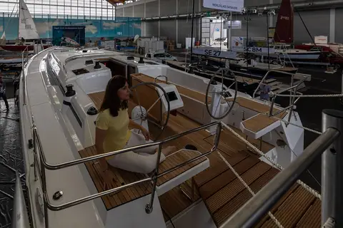 Visitor seated at the twin helms of a Bavaria C42 cockpit