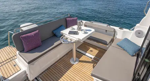 Beneteau Antares 8 cockpit with sliding bench, table and teak style sole