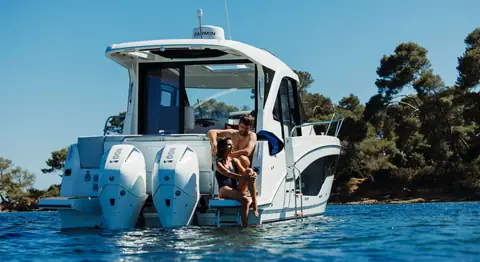 Beneteau Antares 9 stern with twin Mercury outboards and swim platform at anchor
