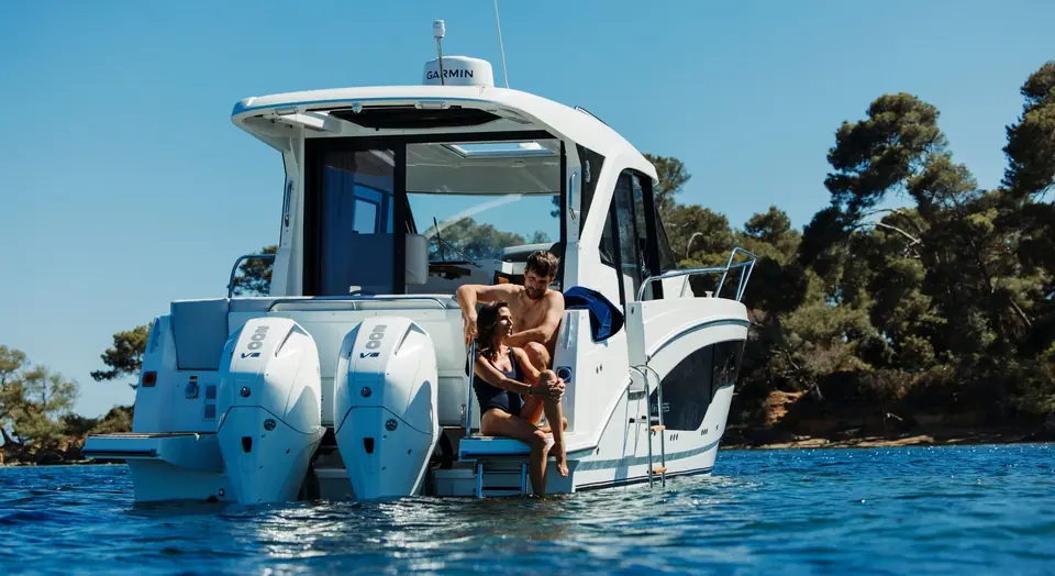 Beneteau Antares 9 stern with twin Mercury outboards and swim platform at anchor