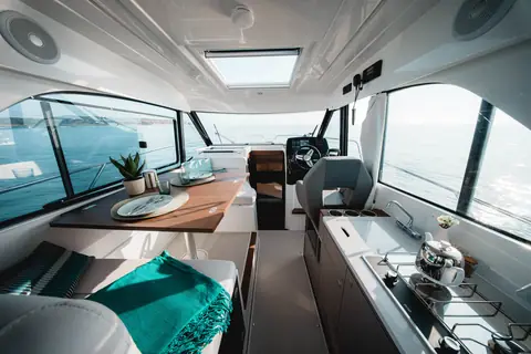 Beneteau Antares 9 wheelhouse with dinette, galley and helm under a large skylight