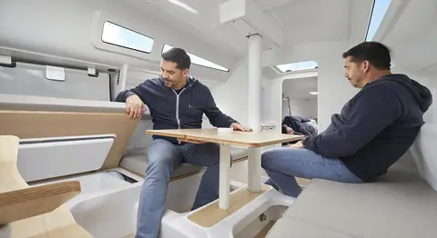 Beneteau First 27 saloon with settees either side of a folding table