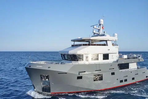 Bering 77 Veronika underway seen from the bow quarter with its steel hull and flybridge