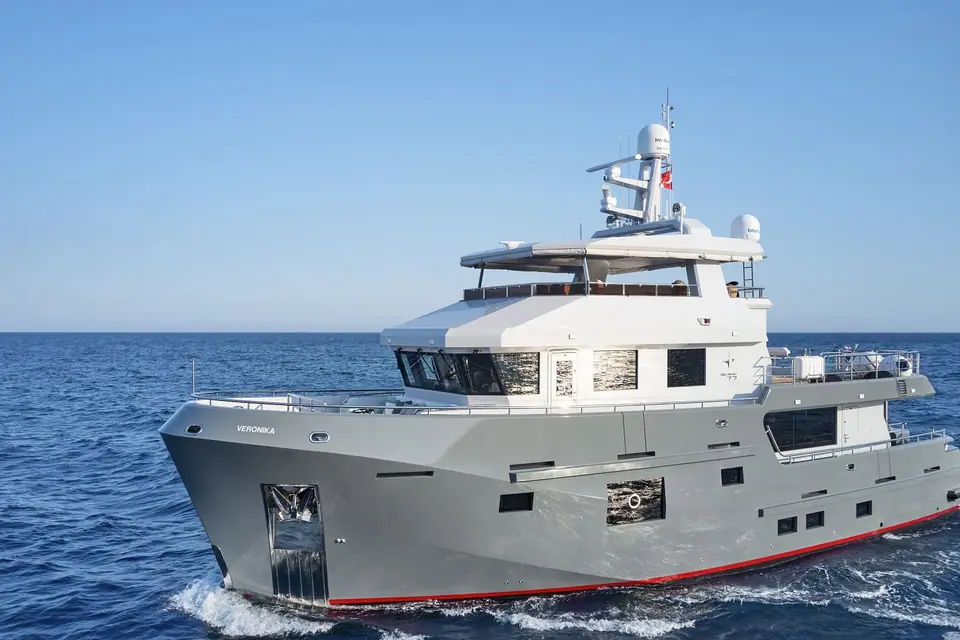 Bering 77 Veronika underway seen from the bow quarter with its steel hull and flybridge