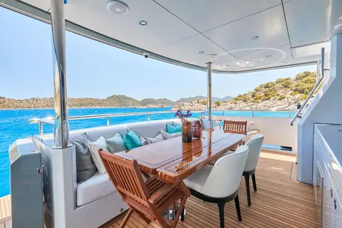 Bering 77 Veronika flybridge dining table and lounge under the hardtop
