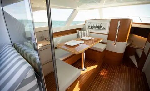 Salon dinette of the Bertram 35 with teak cabinetry