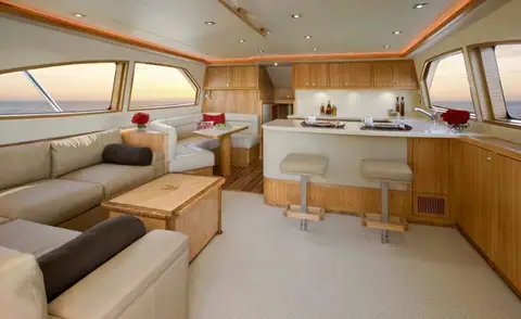 Salon of the Bertram 54 Convertible with teak joinery and an L shaped settee