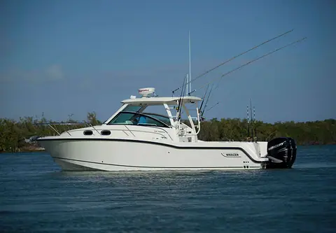 Boston Whaler 315 Conquest at rest in profile with twin outboards
