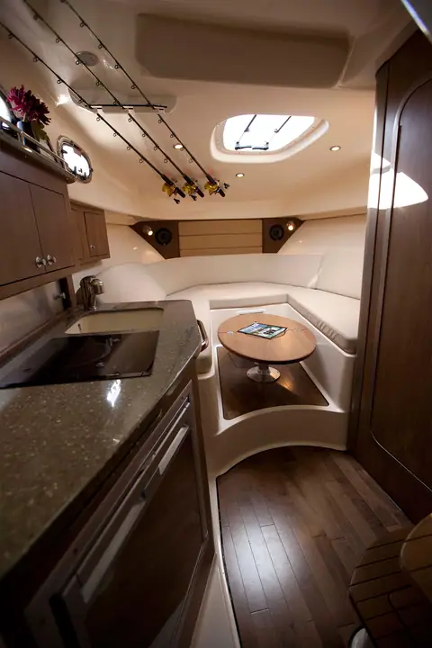 Cabin of the Boston Whaler 315 Conquest with galley, dinette and wood floor