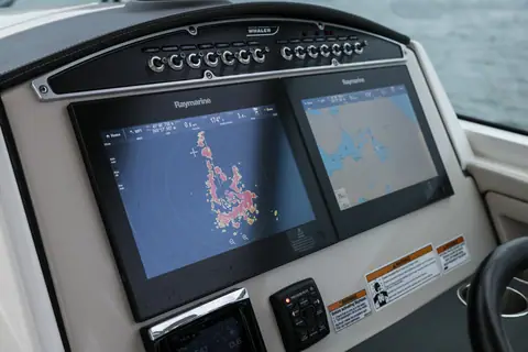 Helm dash of the Boston Whaler 320 Vantage with twin Raymarine displays