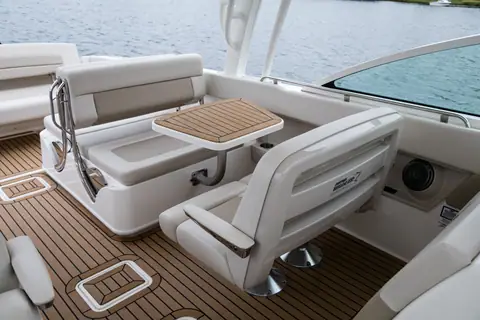 Cockpit seating and teak table of the Boston Whaler 320 Vantage