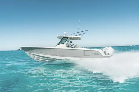 Boston Whaler 330 Outrage running in profile on turquoise water