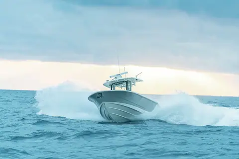 Boston Whaler 330 Outrage running head on through a wave